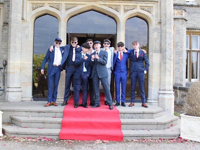 A group of teenage friends outside their prom venue.