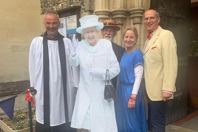 Father Stuart Owen and members of the parish with a cut out of the Queen at St Peter's.