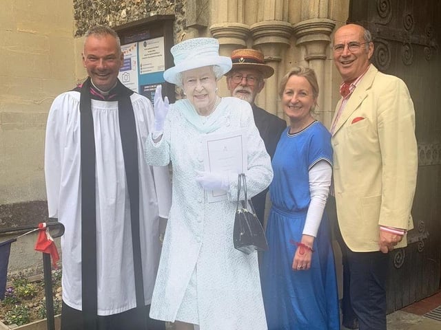 Father Stuart Owen and members of the parish with a cut out of the Queen at St Peter's.