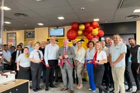 Sir Mike Penning MP cuts the ribbon at the restaurant.