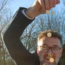 Charles Hanson with some of the gold coins found in a linen box, photo from Nathan Fitzsimmons/Hansons