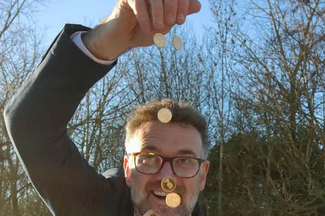 Charles Hanson with some of the gold coins found in a linen box, photo from Nathan Fitzsimmons/Hansons