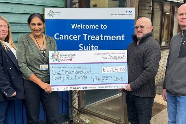 Mary Keenan, Craig Wild and Andy Greenwood from the Three Tuns pub in Apsley present a cheque to Jagdeep Kudhail, head of radiation services, at Mount Vernon Cancer Centre to mark the start of their partnership