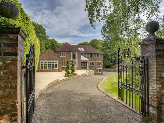 Savills in Harpenden has this six-bedroom house on the market with a guide price of £4,000,000. This property is on a private road on the edge of National Trust land in Potten End. It has lots of modern features, including a snooker room, cinema/gym, gated entrance and a garage with a room above.