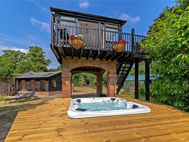 One the land is a summerhouse on stilt. It's currently used as an outdoor dining room with its own balcony, ideal for summer dinner parties. Underneath there is a jacuzzi, ad the nearby barn has been converted into a gym.