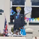 A scarecrow of Boris Johnson seen with bottles of wine and party decorations.