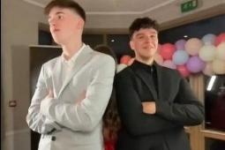 Teens pose in their suits.