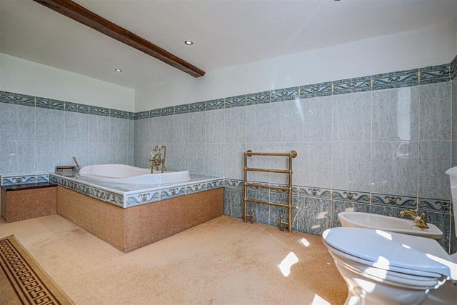 This bathroom, with a deep-set tub and a bidet, is one of two bathrooms as well as a shower room and en suite.