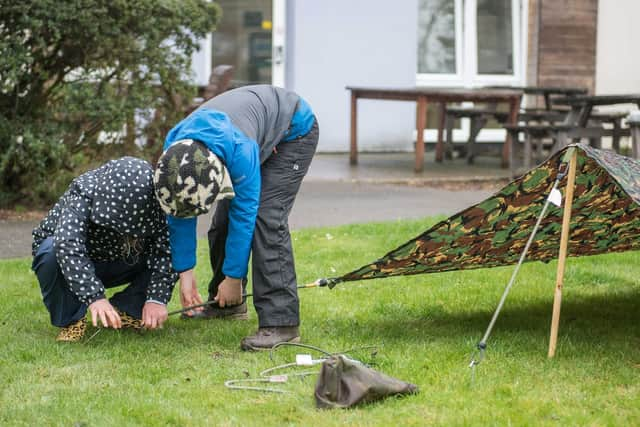 School children learning how to build a shelter at Northwood HQ - part of their prize for winning the Hertfordshire Heroes Christmas Art competition