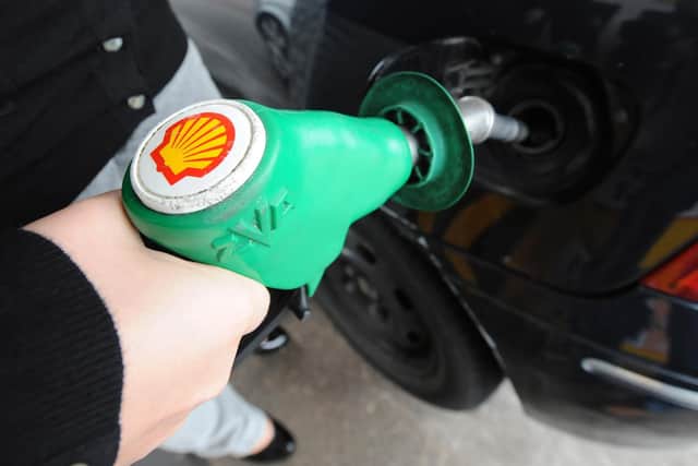 A person fills up at a Shell petrol station