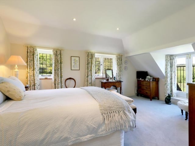The spacious principal bedroom has a walk in wardrobe and en suite and the guest bedroom has an en suite shower room.