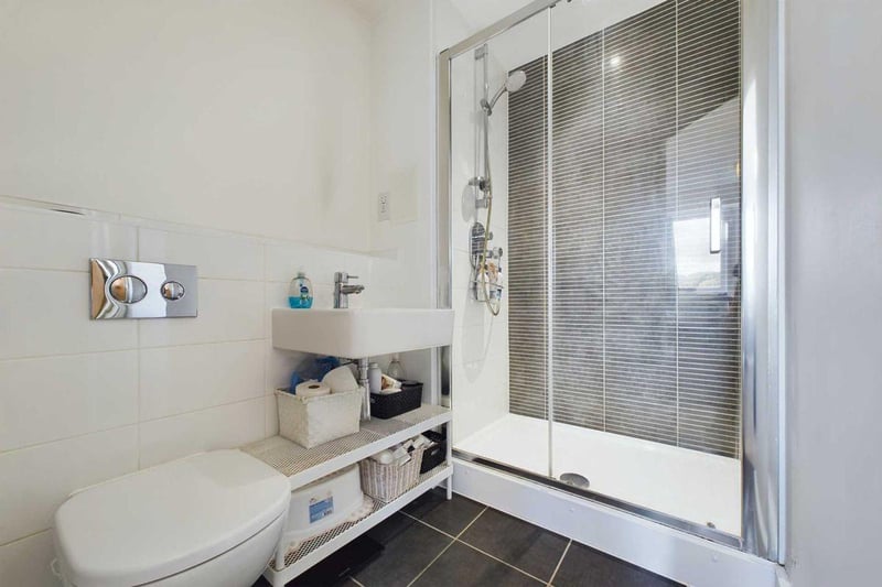 A luxury en suite bathroom includes a large shower.