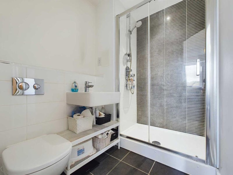 A luxury en suite bathroom includes a large shower.