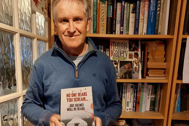 Alastair holds up his second novel