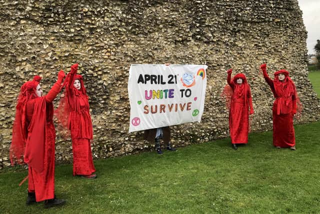 Red Rebels from Extinction Rebellion at Berkhamsted Castle inviting everyone to gather at Westminster for The Big One, aimed at averting climate catastrophe