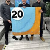 Turkish barber Serhat Yelocagi (left) with businessman Paul Smith (centre) who bought a painting for £3,000 to help relief efforts after the devastating earthquake in Turkey. It was donated by artist Stephen Charlton (right). Both men are clients at the Barber Lads in Berkamsted High Street