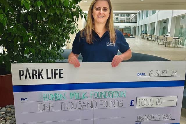 Felicity from Human Milk Foundation receiving the donation