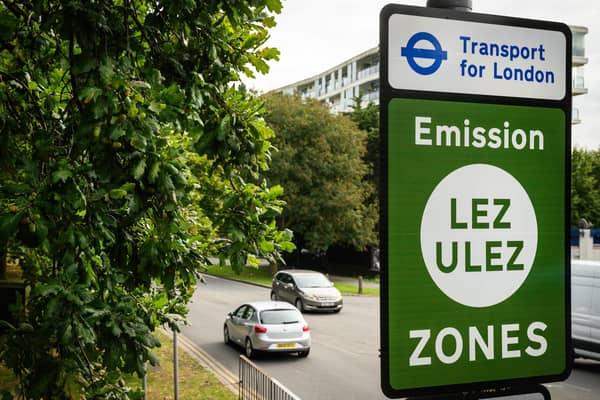 Vehicles pass by a sign indicating the new boundary of the LEZ and ULEZ expansion on August 29. Credit: Leon Neal/Getty Images.