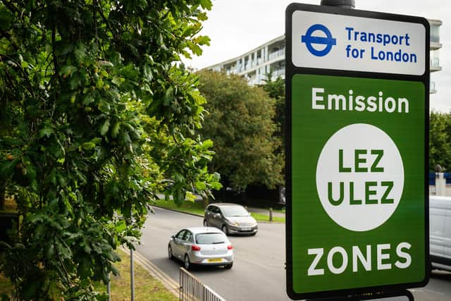Vehicles pass by a sign indicating the new boundary of the LEZ and ULEZ expansion on August 29. Credit: Leon Neal/Getty Images.