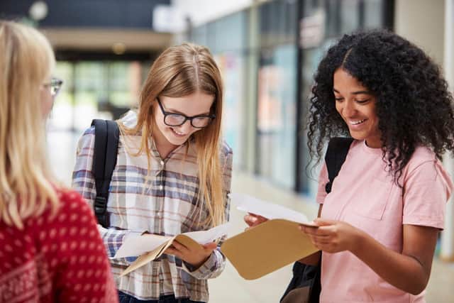Two young women open their exam results