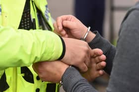 An individual being handcuffed. Photo from Joe Giddens/PA Images