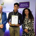 Cllr Caroline Clapper and council chairman Terry Douris present the award to Saavan.