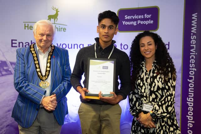 Cllr Caroline Clapper and council chairman Terry Douris present the award to Saavan.