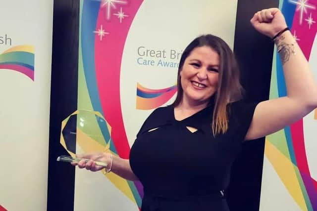 Emma celebrating with her award