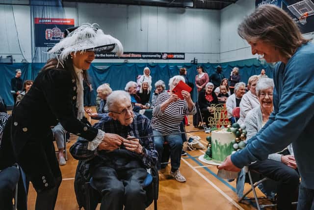 The birthday cake was cut with a ceremonial sword