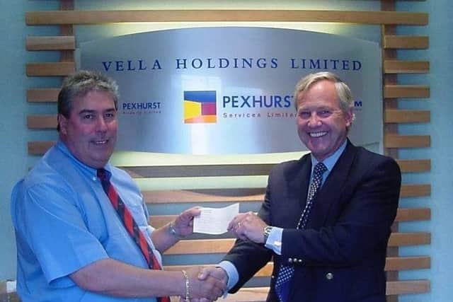 Pexhurst's late founder John Vella handing over the first cheque for charity in 2000