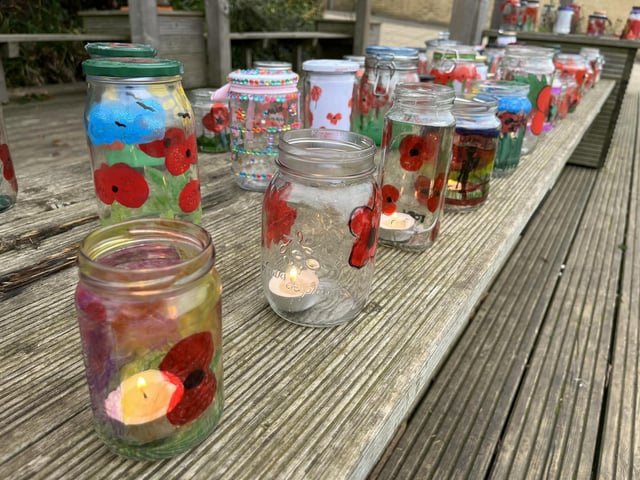 The jars were painted with poppies and had a candle placed inside