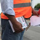 An RMT union campaigner hands out leaflets opposing ticket office cuts in Cheshunt, Hertfordshire. Credit: Will Durrant/LDRS