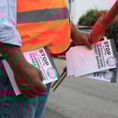 An RMT union campaigner hands out leaflets opposing ticket office cuts in Cheshunt, Hertfordshire. Credit: Will Durrant/LDRS