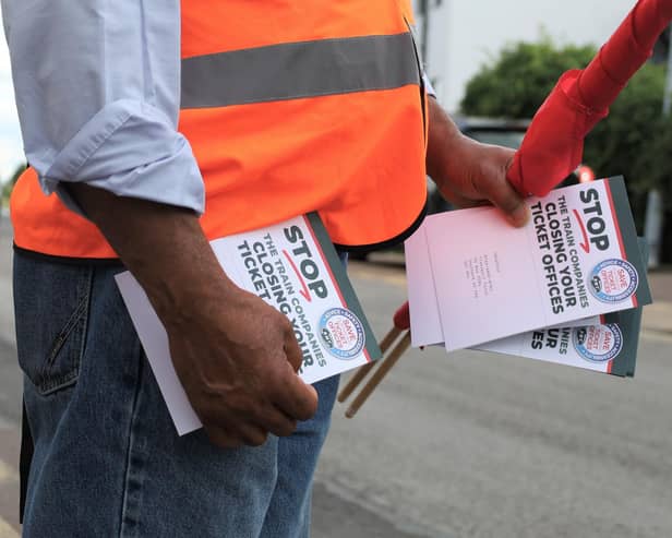 An RMT union campaigner hands out leaflets opposing ticket office cuts in Cheshunt, Hertfordshire. Credit: Will Durrant/LDRS