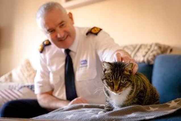 Dermot Murphy, RSPCA inspectorate commissioner, with one of the charity's many rescued cats.