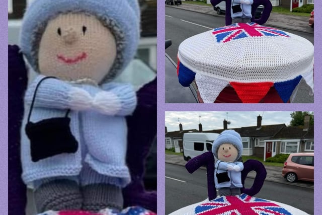 Woollen Queen figure with a small black handbag on a knitted postbox topper. 
Photo: Chris Allsop