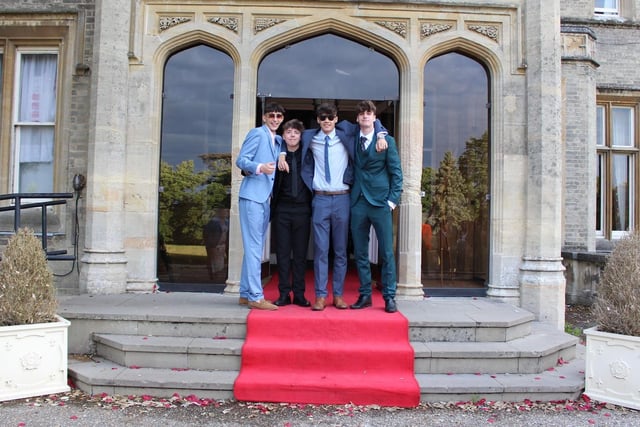 Four friends pose in their suits as they enter Shendish Manor.