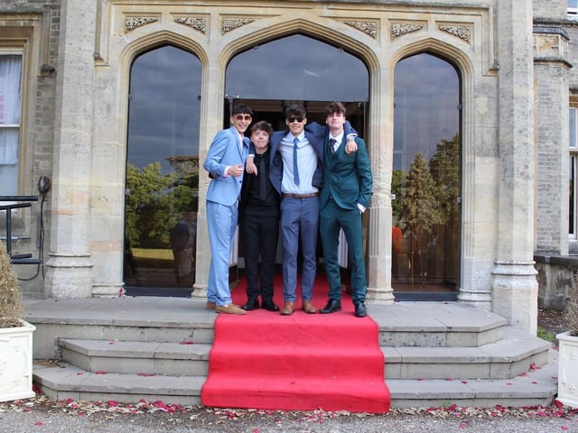 Four friends pose in their suits as they enter Shendish Manor.