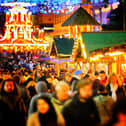 There's nothing warming yourself with a hot drink walking around Christmassy stalls on a wintery evening! Picture: Christopher Furlong/Getty Images