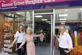 Deborah Gould (middle) with shop's volunteers as reopening ceremony.