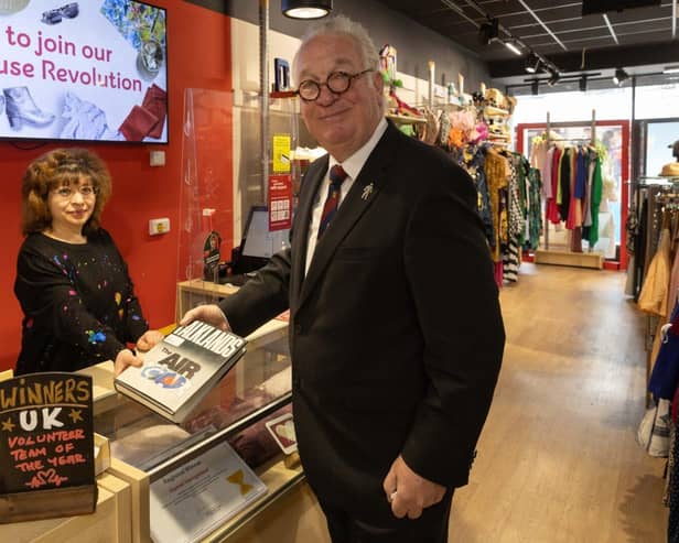 Sir Mike Penning purchases at a book at Hemel Hempstead British Heart Foundation.