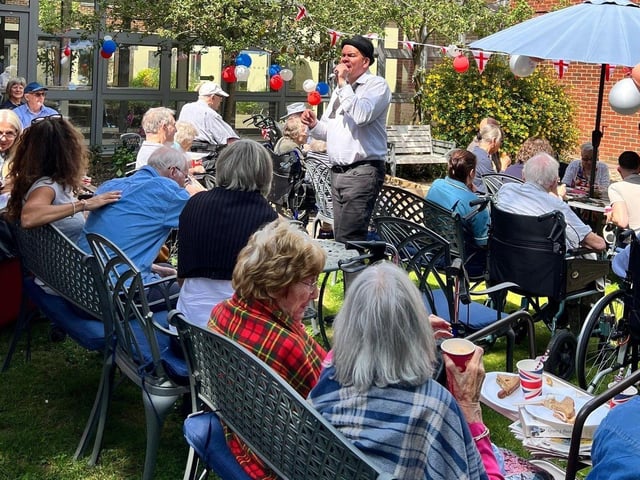 Residents at St Pauls Care Centre enjoying an outdoor celebration for the Kings Birthday