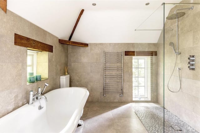 The bathroom has a large walk-in shower and underfloor heating.