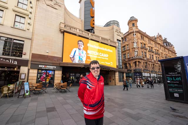 Mitch in-front of the large billboard in London's Leicester Square