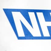 NHS logo, photo from Yui Mok/ PA Wire/PA Images