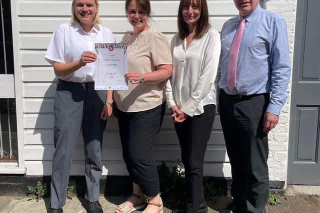 The team at J Stifford receive their Will Aid certificate from Age UK representative, Rebecca Rogerson (far left)