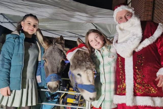 Children visiting Santa and his reindeer at St Pauls Care Centre Christmas Market