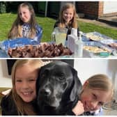 Sisters, Katie and Lilia with their dog, Sammy after selling cakes for Ukraine on Sunday.