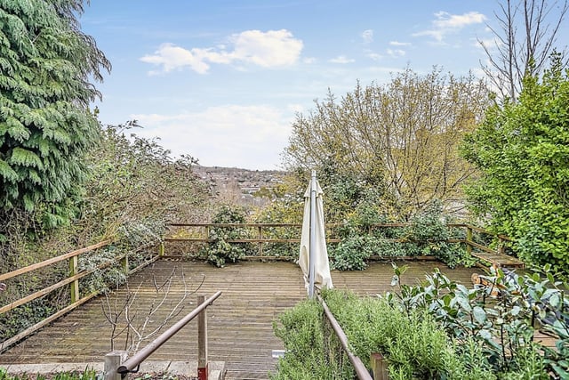 The private decked back garden which provides the owner with a unique view of the town. It also boasts mature hedges and raised planters.