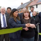Cllr Simy Dhyani and tenant Linda James cut the ribbon at the official opening of the Wilstone development. Image submitted .